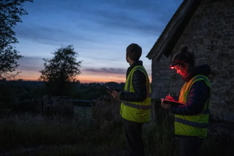 An ecologist carrying out a bat survey at dusk